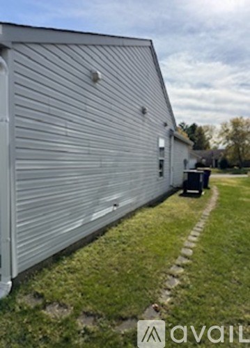 A silver building with a striped facade.