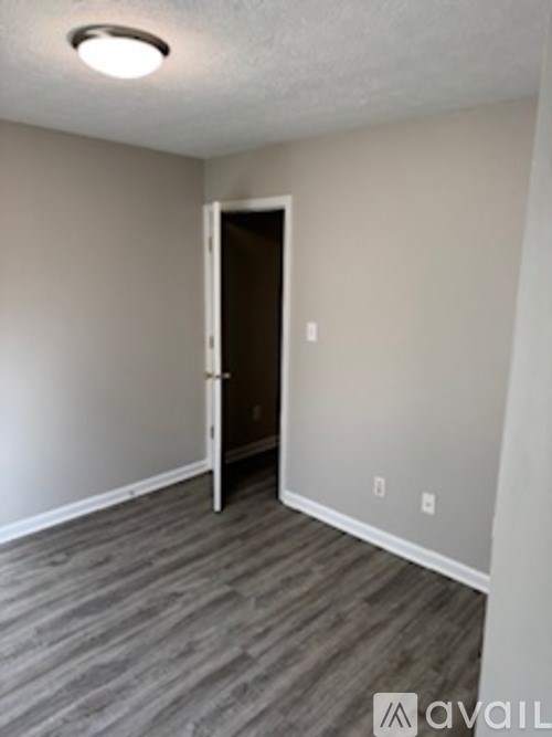 A room with a door and a light on the ceiling.