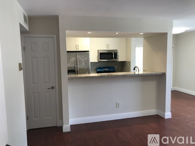 A kitchen area with a countertop and a microwave.