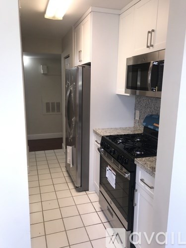 A kitchen with a black stove and a black fridge.