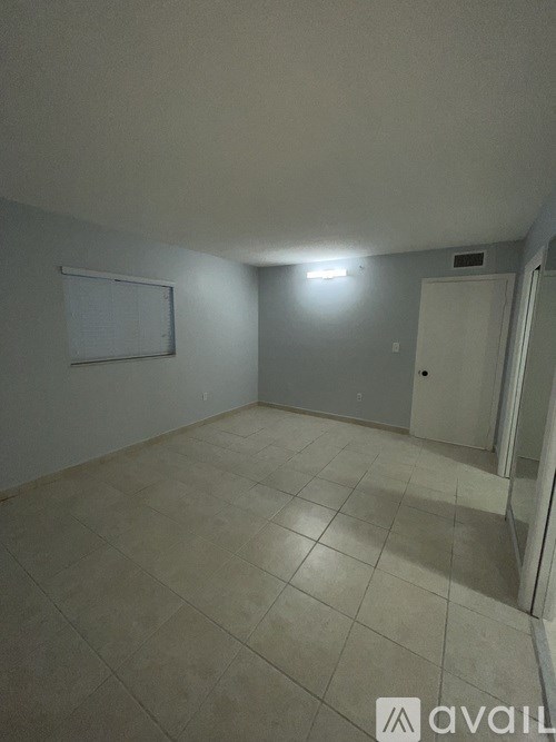 A room with a whiteboard and a door.