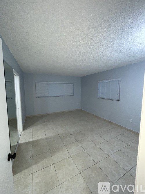 A room with tile flooring and a white ceiling.