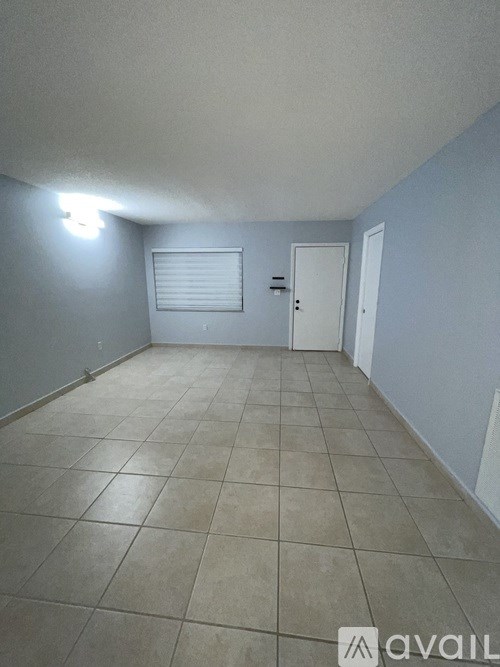 A room with tiled flooring and a single door.