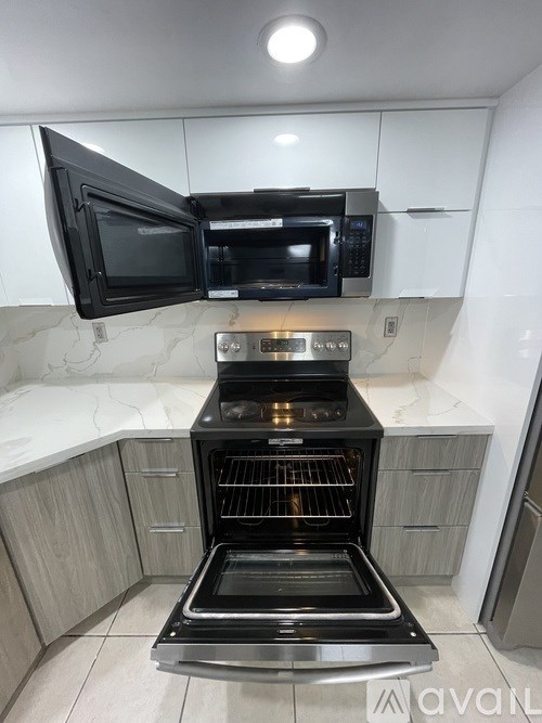 A black oven with a glass door is in a kitchen.