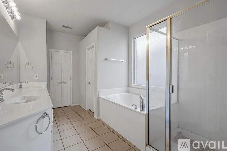 A bathroom with a white tub, sink, and toilet.