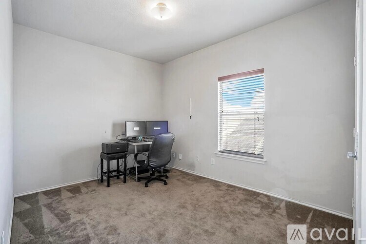 A room with a desk and a computer on it.