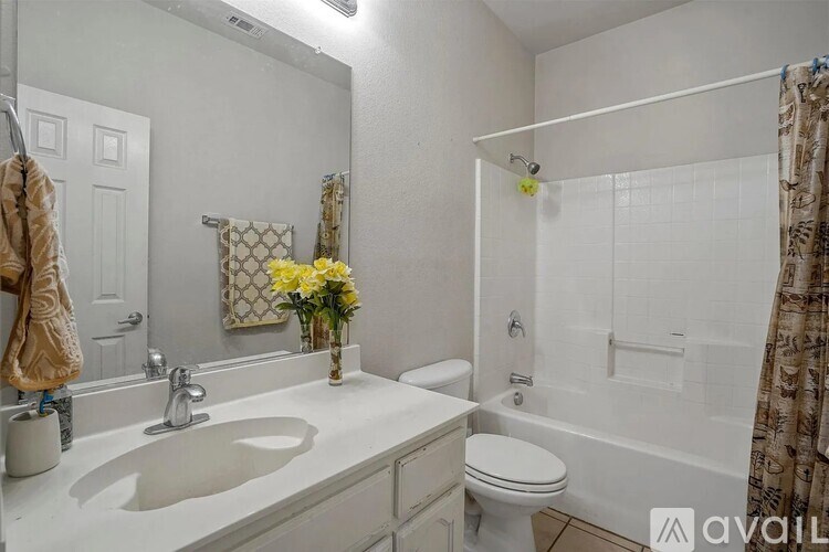 A bathroom with a white sink, toilet, and bathtub.