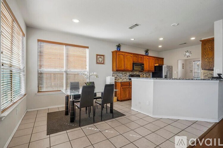 A kitchen with white appliances and wooden cabinets.