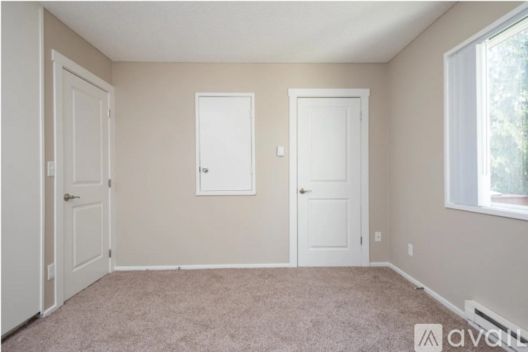 A room with two doors and a window.