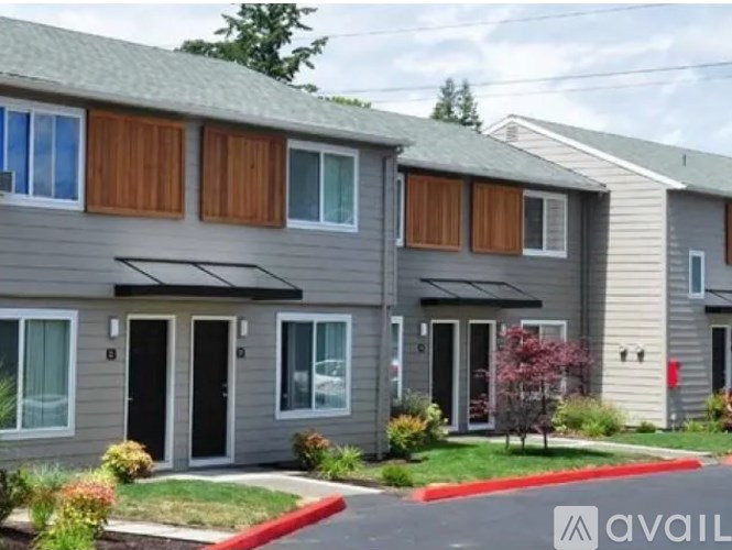 A row of houses with the word AVAILABLE on the front lawn.