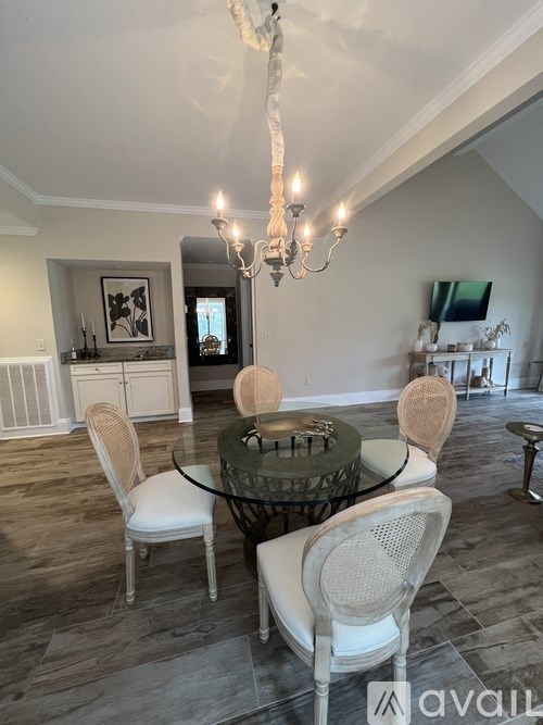 A dining room with a glass table and chairs.