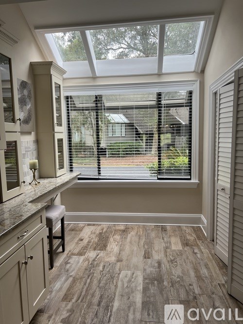 A kitchen with a window seat and a counter.