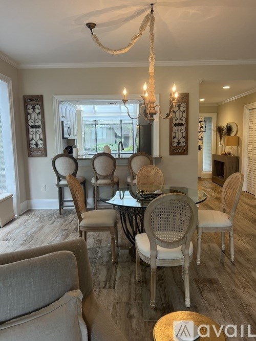 A dining room with a glass table and chairs.
