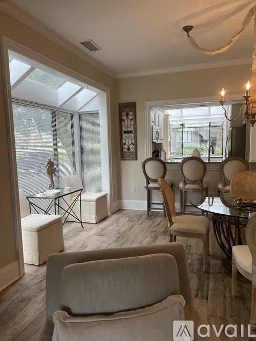 A living room with a glass table and chairs.