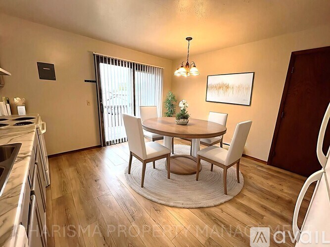 A dining room with a round table and chairs.