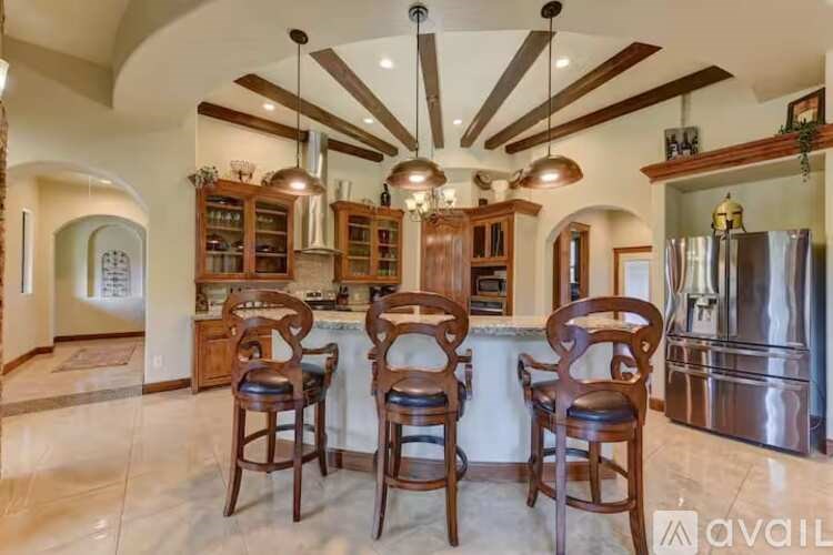 A kitchen with a bar area and four chairs.