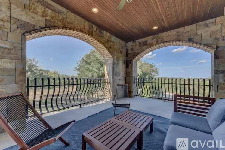 A patio with a wooden table and chairs is available for rent.