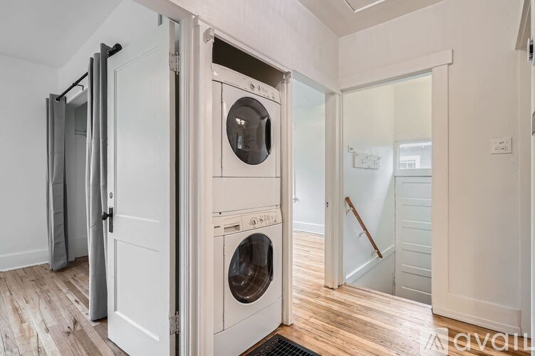 A washing machine is built into a wall in a laundry room.