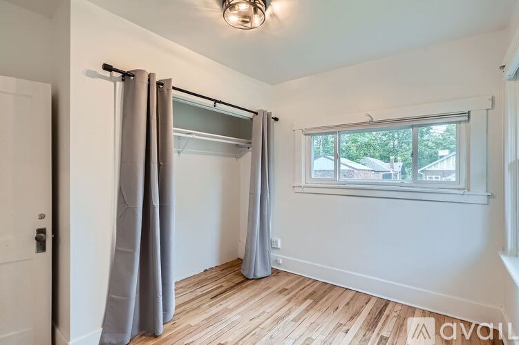 A room with a window and a sliding door.