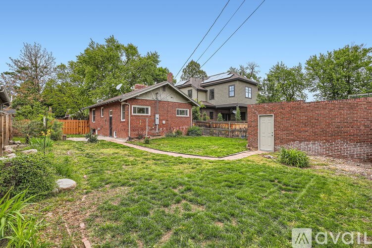 A house with a backyard and a fence.