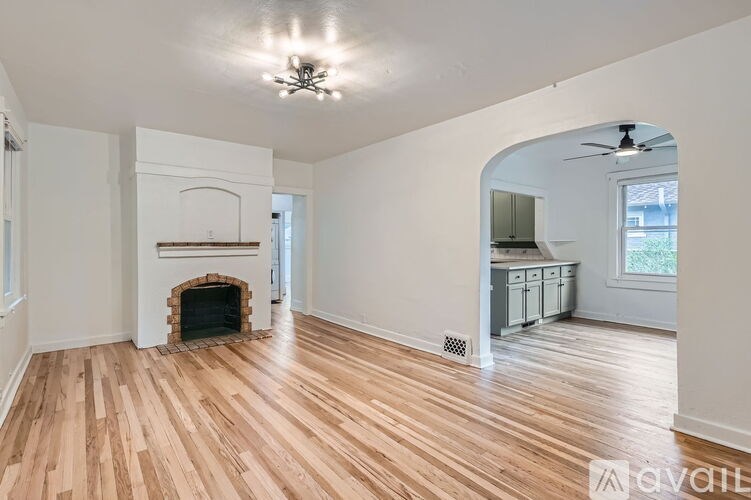 A room with a fireplace and hardwood floors.