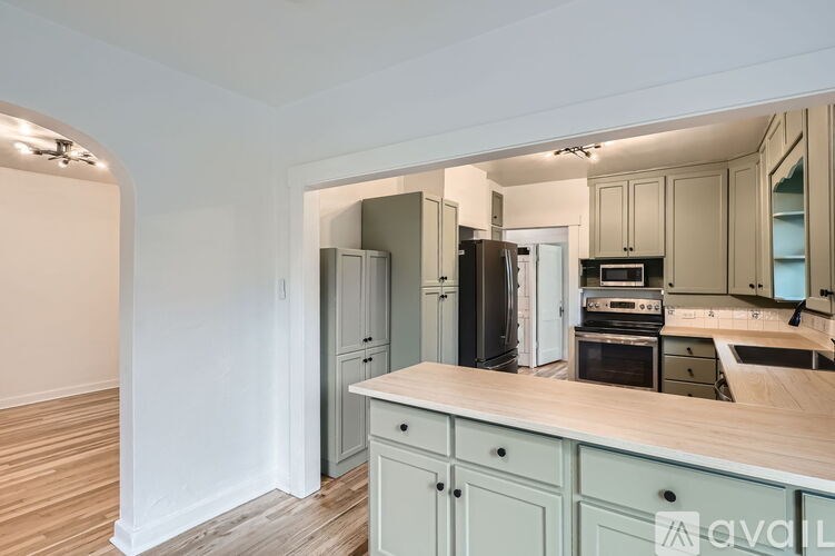 A kitchen with a wooden counter and cabinets.