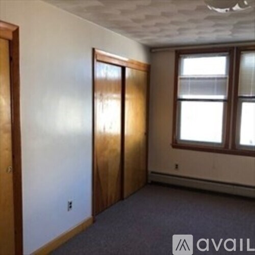 A room with a window and a door.