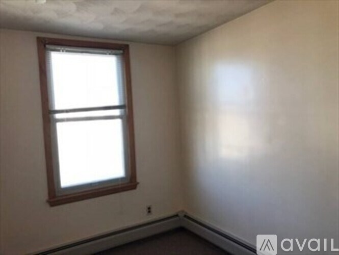 A room with a window and a wall with a line on it.