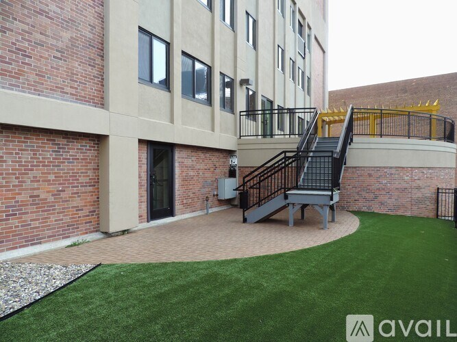 A brick building with a black metal staircase.