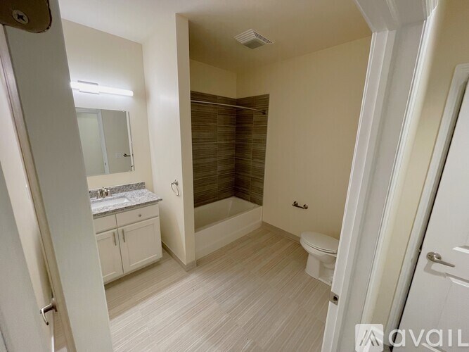 A bathroom with a toilet, sink, and bathtub.