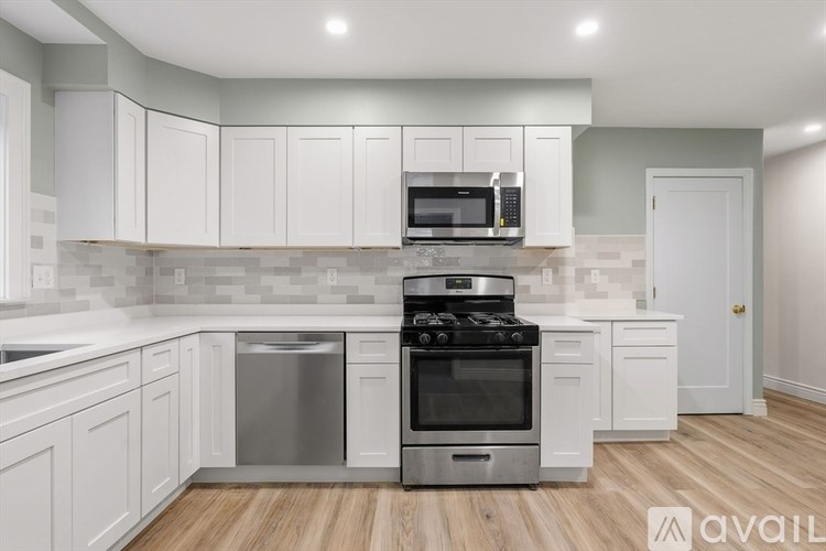 A kitchen with white cabinets and a stainless steel dishwasher.