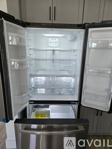 A clean, empty refrigerator with the door open.
