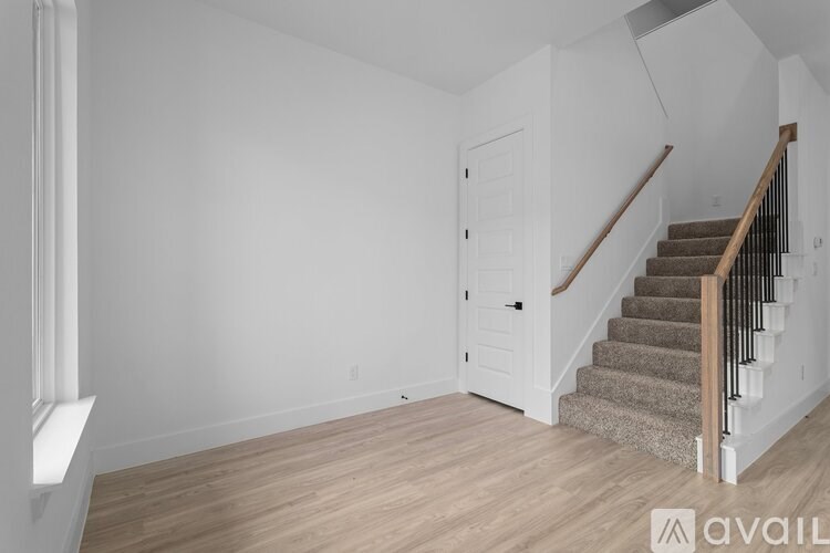 A room with a staircase and a door.