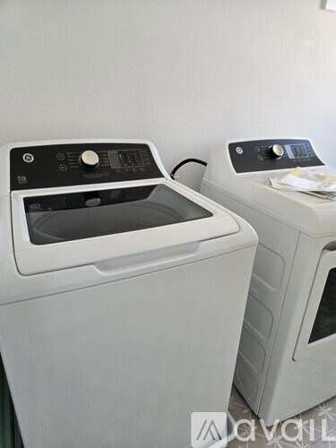 Two front loading washing machines in a laundry room.