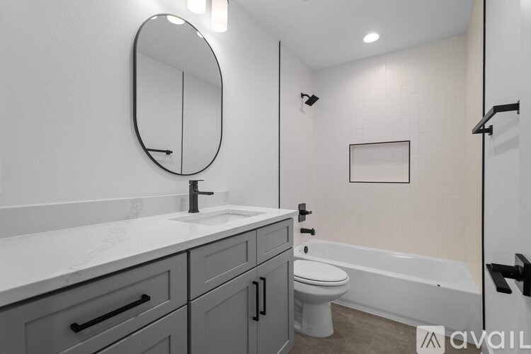 A bathroom with a sink, toilet, and bathtub.
