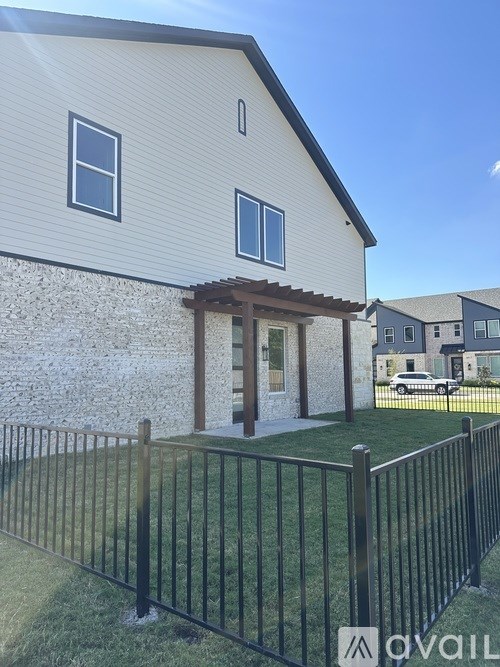 A house with a black fence in front of it.