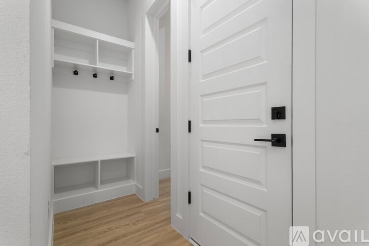 A white door with a black handle is closed.