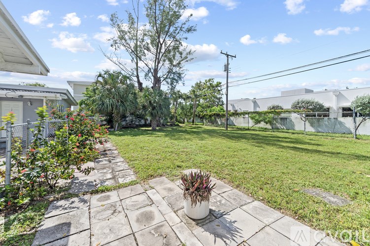 A well-maintained garden with a stone pathway and a potted plant.