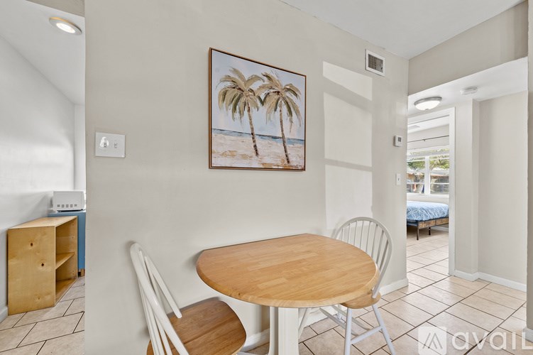 A dining room with a wooden table and chairs.