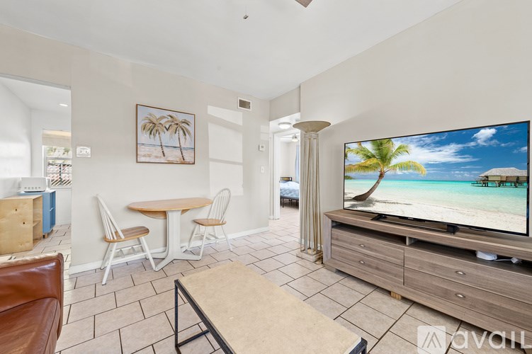 A living room with a television displaying a beach scene.