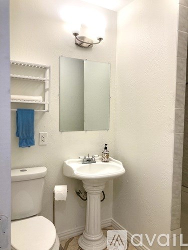 A white sink with a mirror above it in a bathroom.