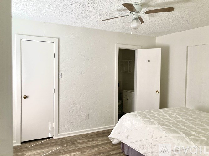 A bedroom with a bed, dresser, and closet.