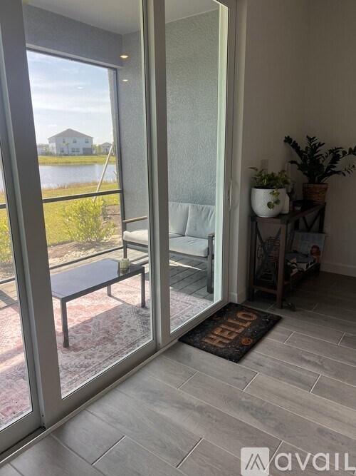 A patio with a table and chairs is visible through a sliding glass door.