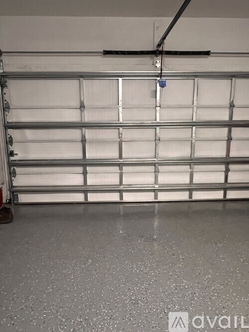 A metal shelf with a blue tag hanging from it.