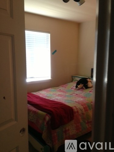 A person is lying on a bed in a small room.