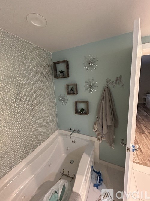 A bathroom with a bathtub and a shower curtain.