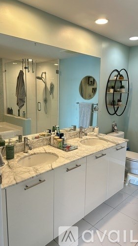 A hallway with a row of paintings on the wall.