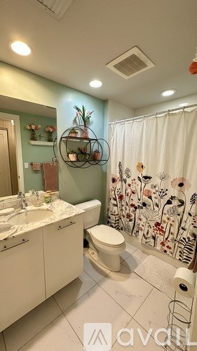 A bedroom with a bed, nightstand, and lamp.