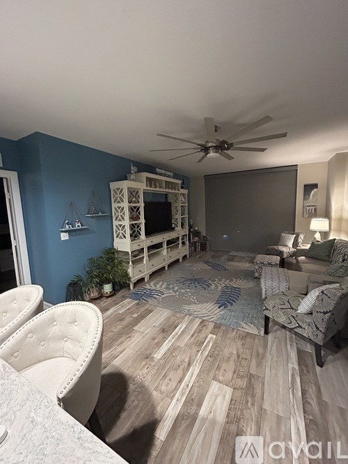 A living room with a blue wall and a white couch.