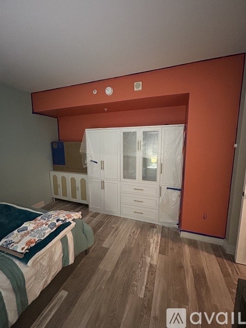 A bedroom with a bed and a wardrobe.